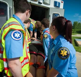 EMS students loading patient into ambulance