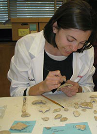 A BIOL student working with artifacts