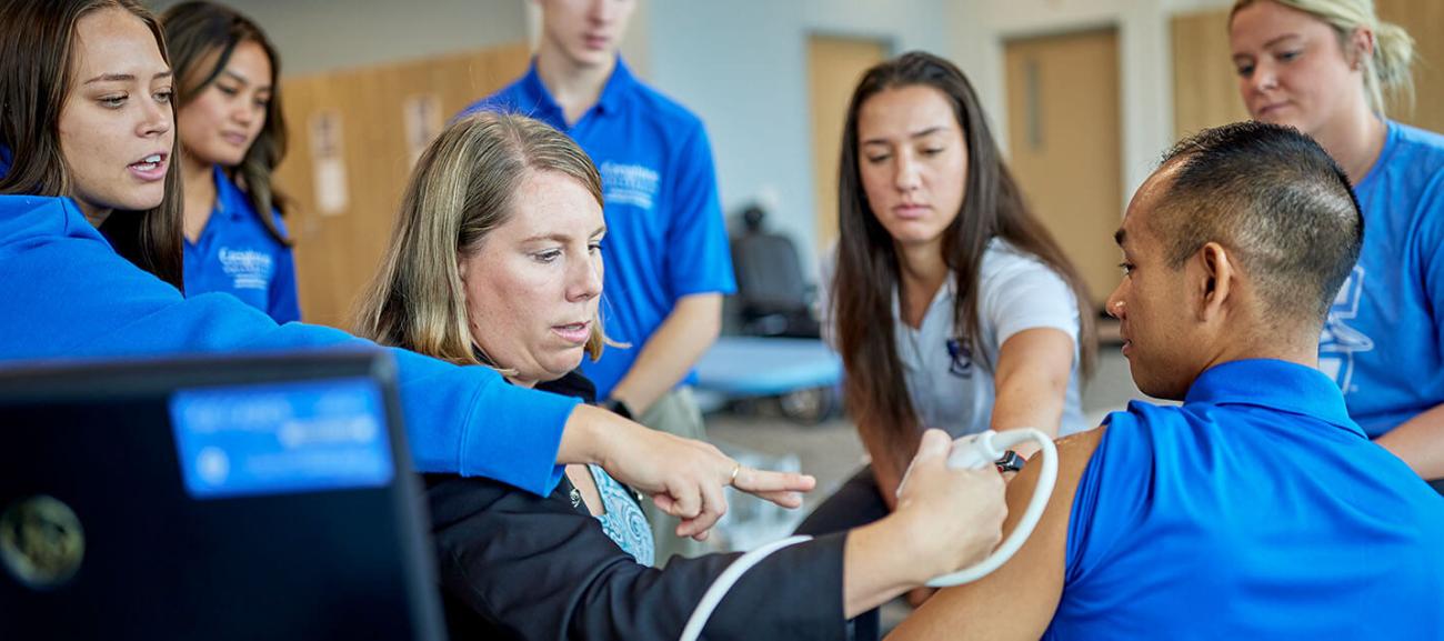 Physical therapy students learning from facutly