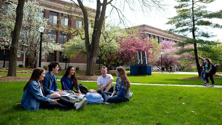 Students sitting on grass on Creighton's campus