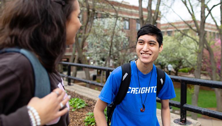 Student in Creighton t-shirt smiling with another student