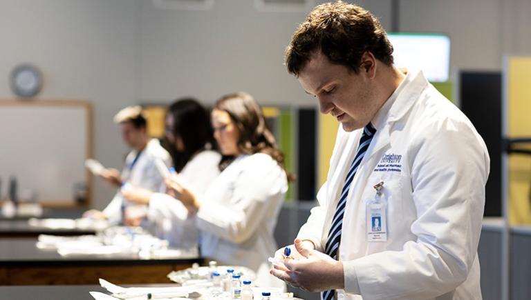 student preparing medicine