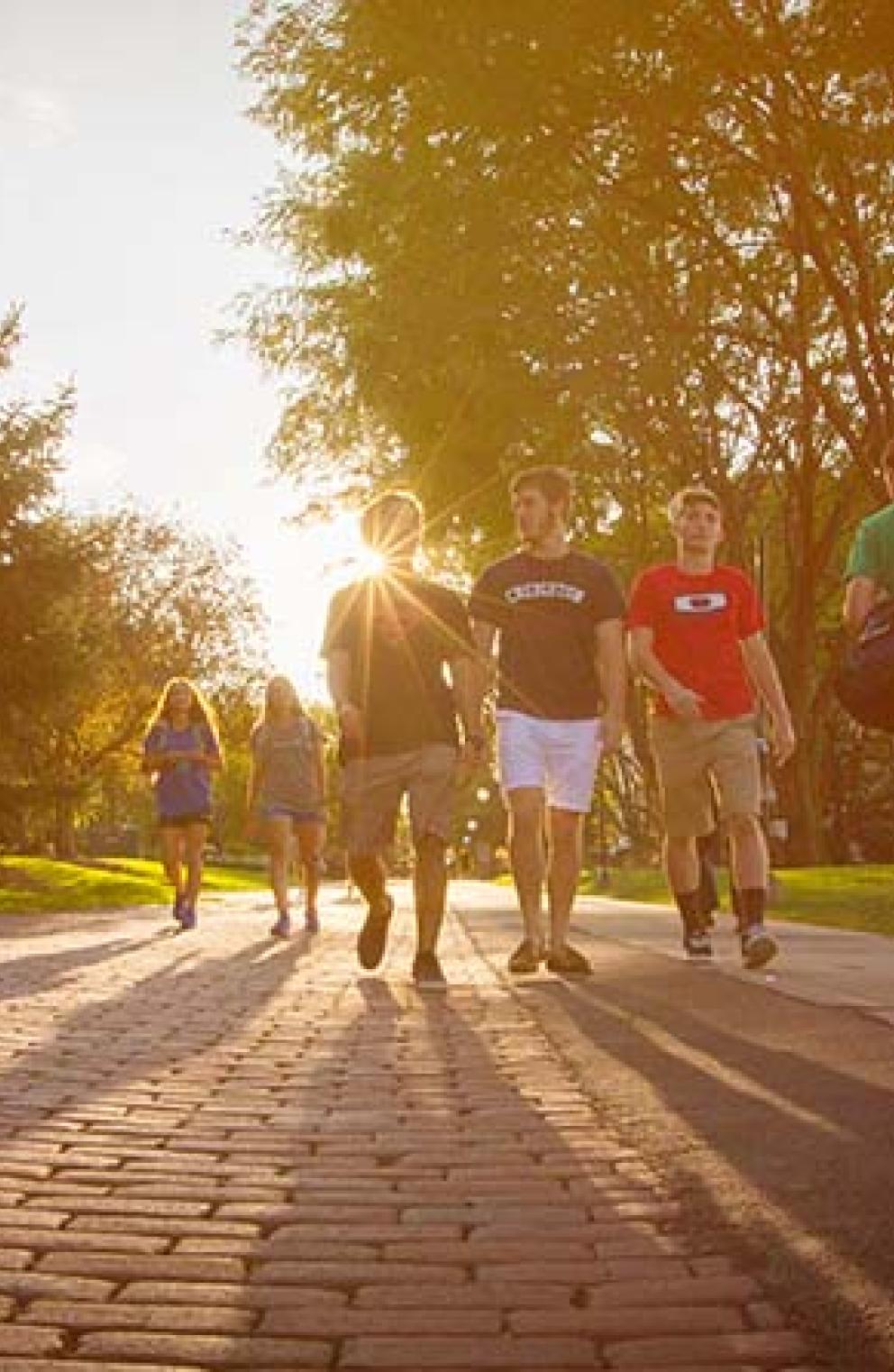 Students walking on Creighton mall pathway.