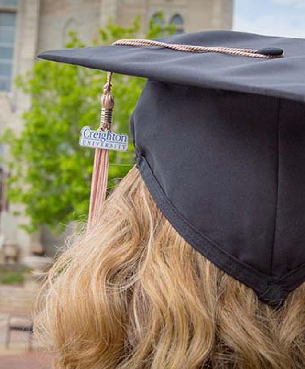 Heider College of Business graduate wearing cap with Creighton university