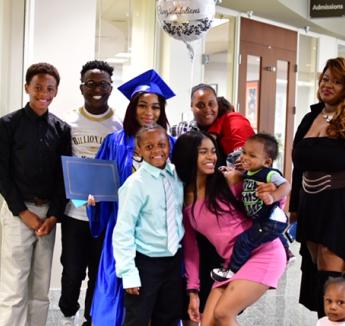 EOC graduate with her family at graduation 