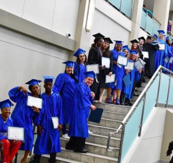 Group of GED graduates on staircase