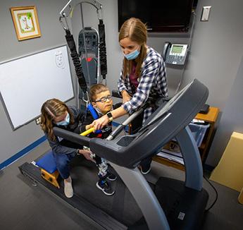 Students helping patient on treadmill