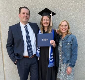 Olivia Moyle with her parents at Creighton graduation ceremony.