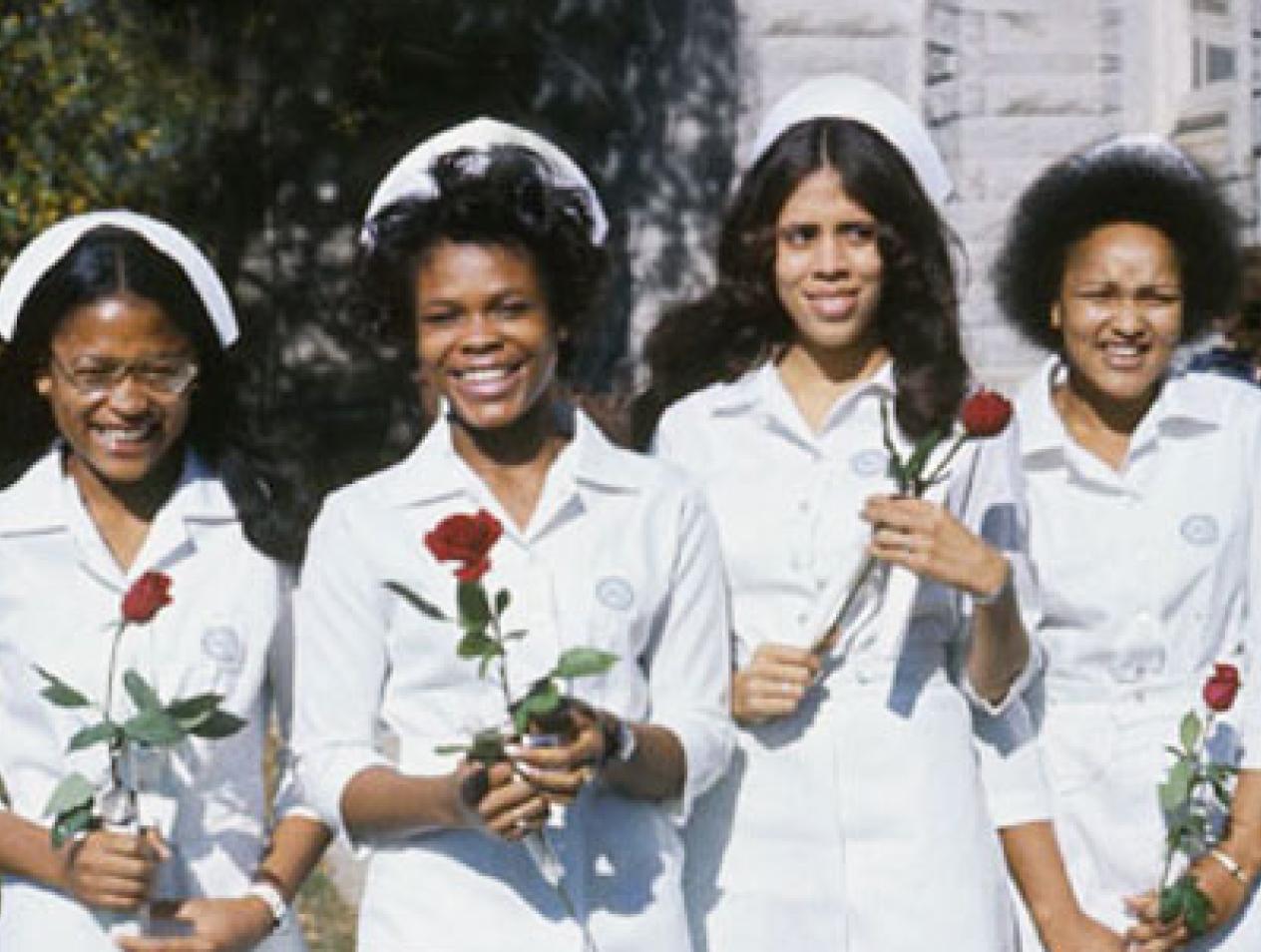 Nurses of color receiving roses at Creighton