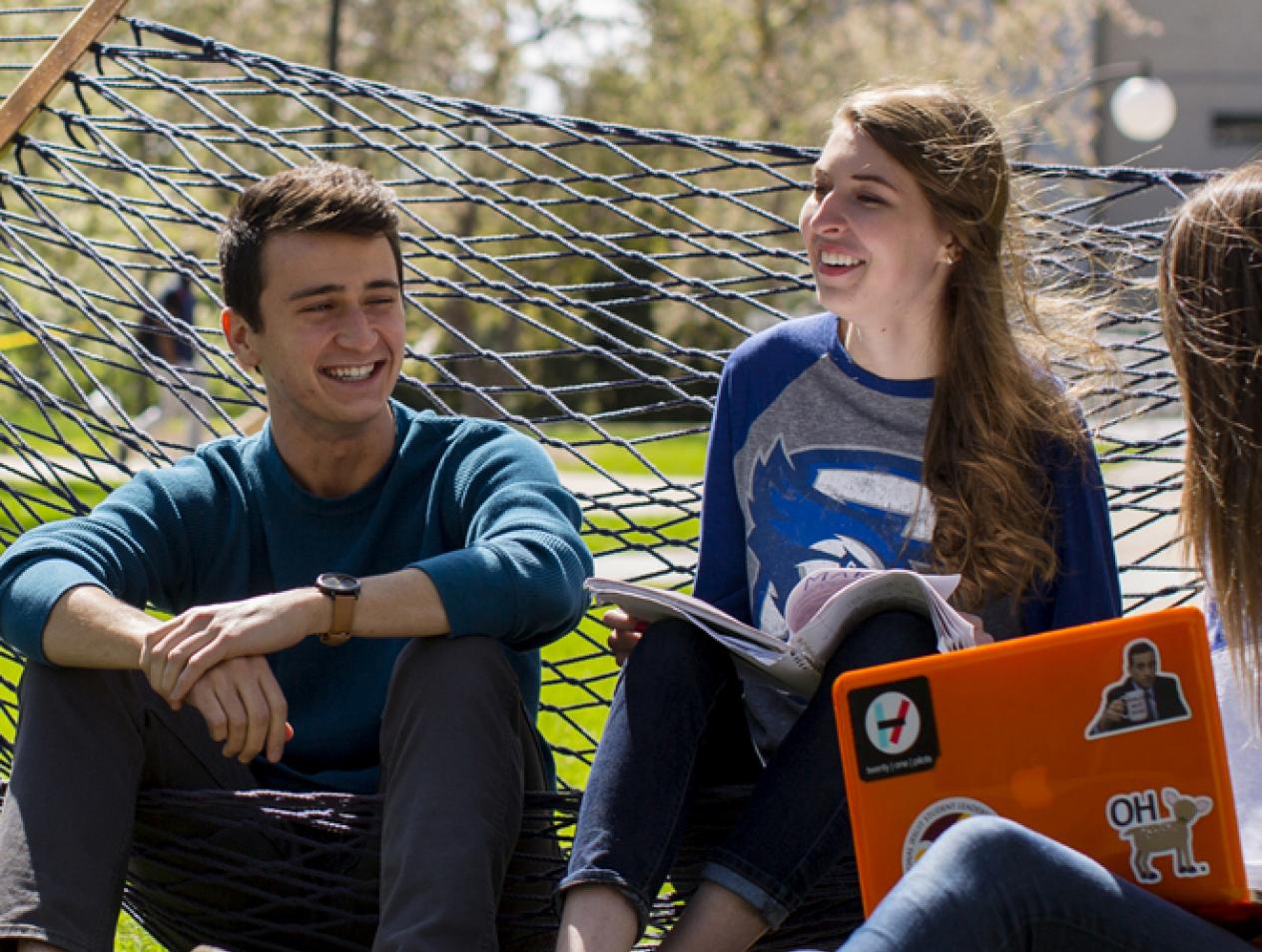 Students socializing in hammocks on Creighton campus