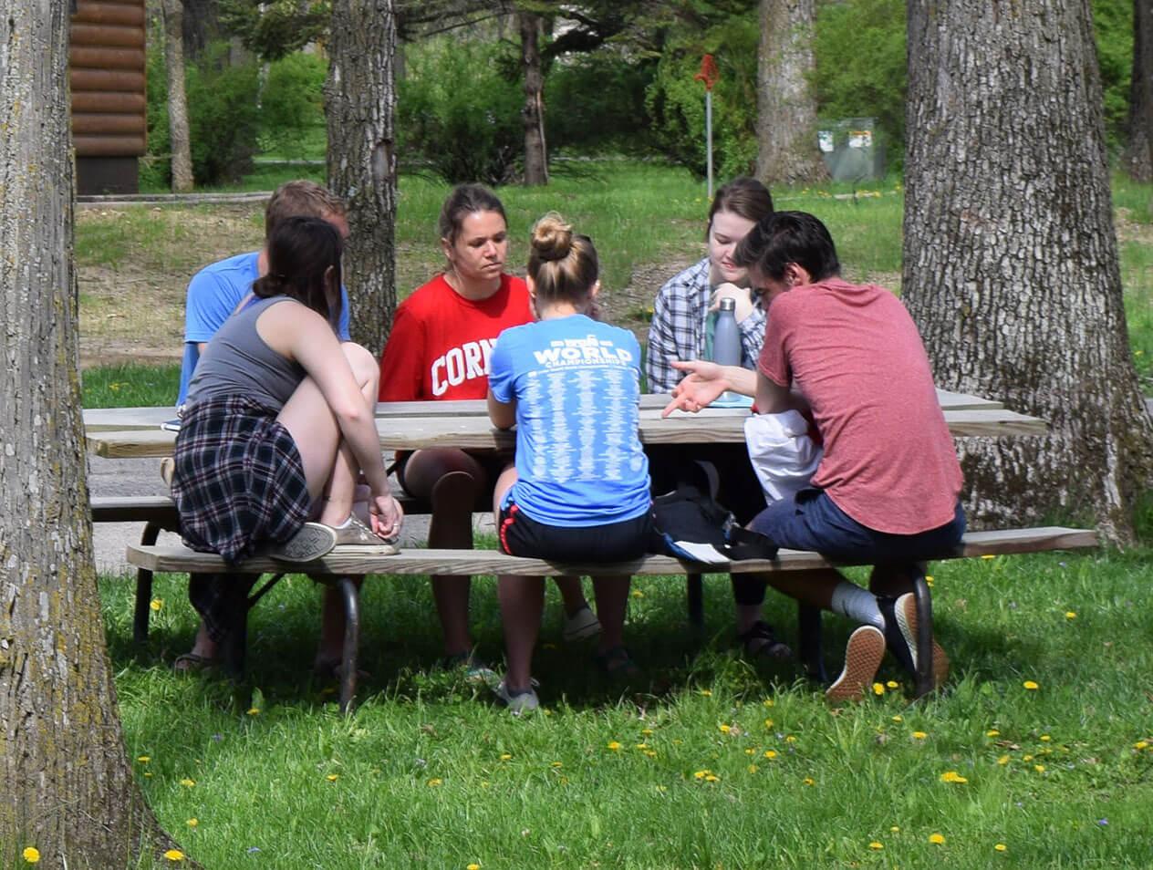 Students at a picnic table during the Senior Retreat