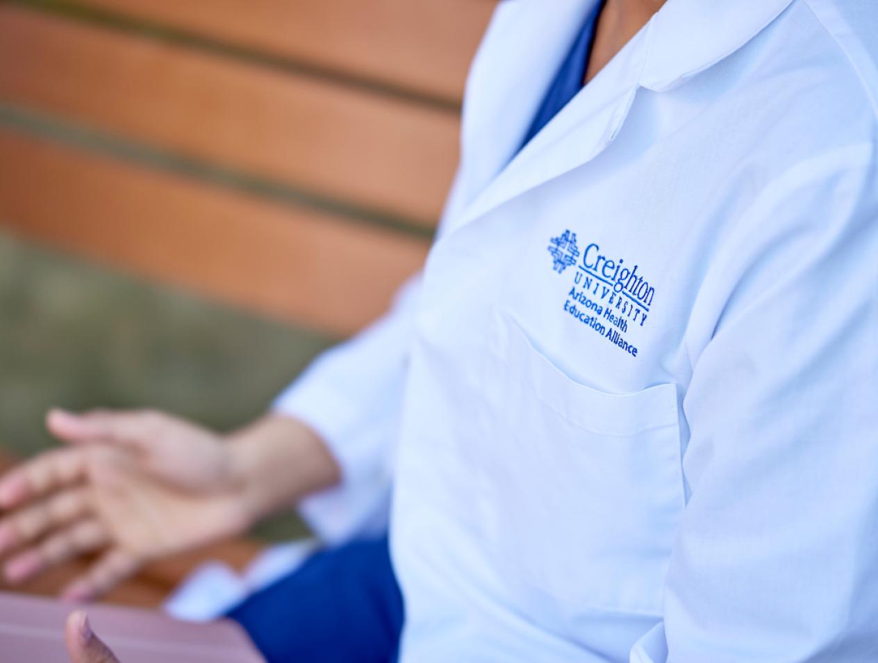 Creighton University healthcare professional in white coat
