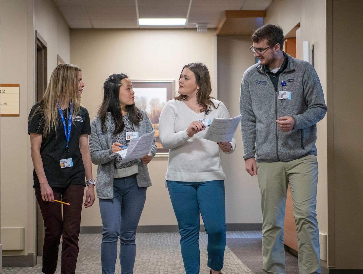 Women's health residents walking consulting together