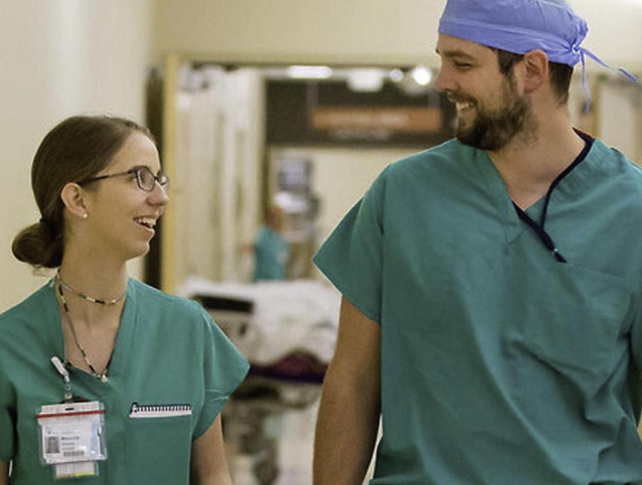 Doctors smiling in green scrubs
