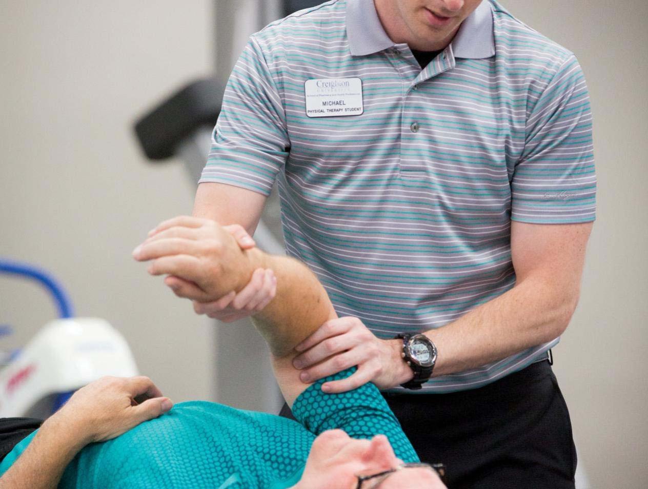 Provider helping patient with his arm