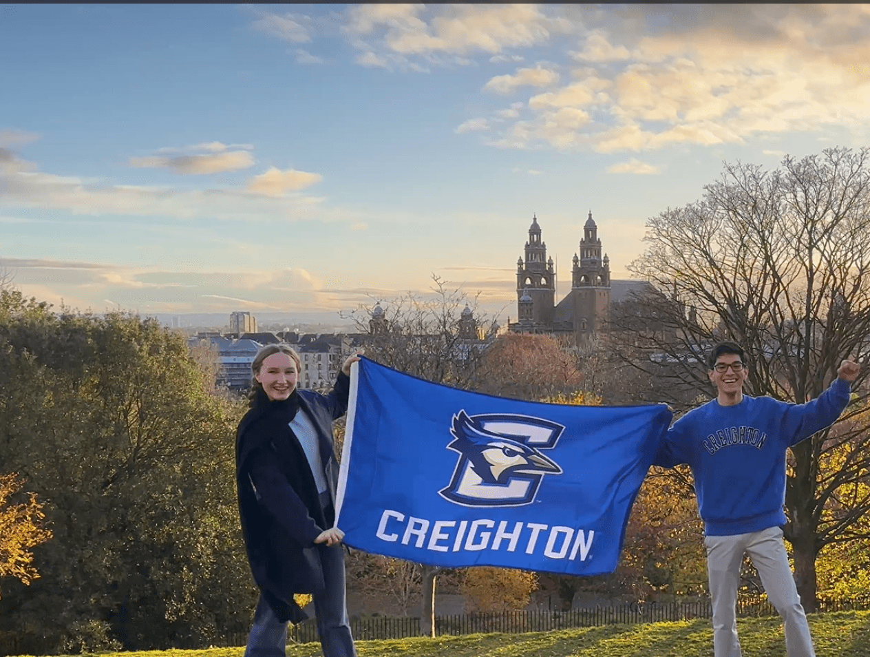 students with creighton flag