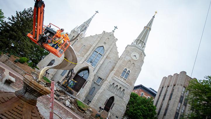 Workers ready the flame to be removed with a harness outside St. John's church.