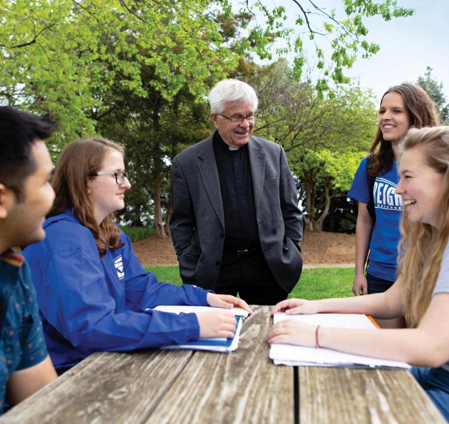 Jesuit faculty teaching in outdoor setting