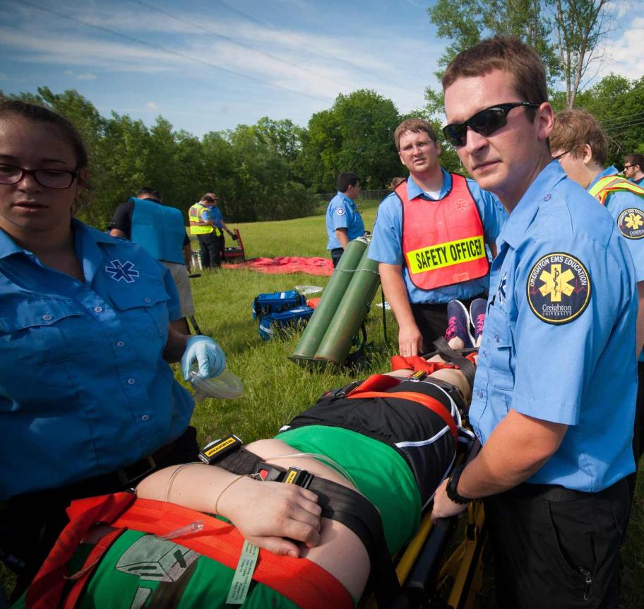 EMS students carrying patient to ambulance