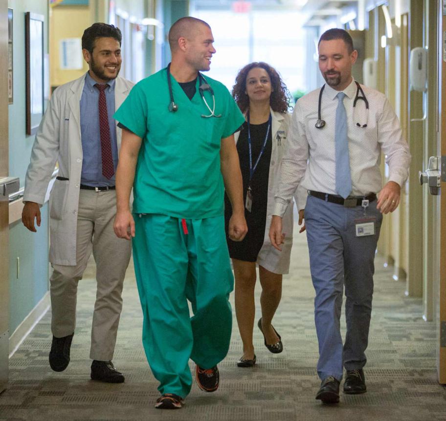 Faculty and leadership walking in hall of hospital