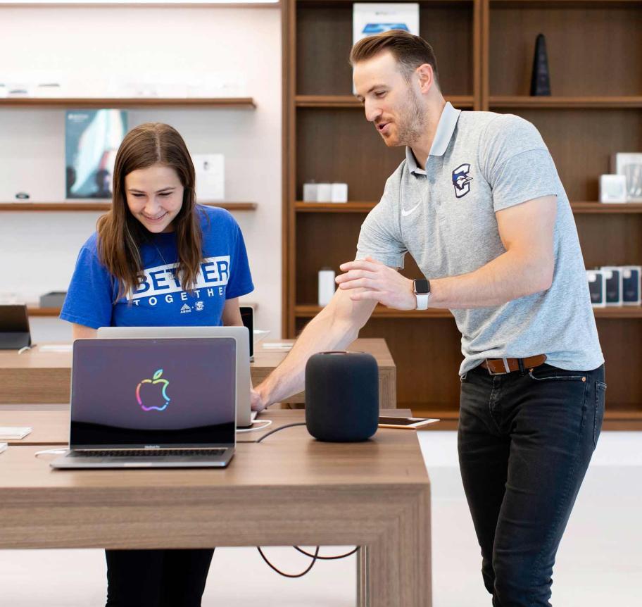 Student looking at laptop in the iJay Store