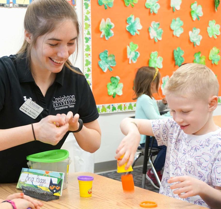 Occupational therapy student working with a childs fine motor skills