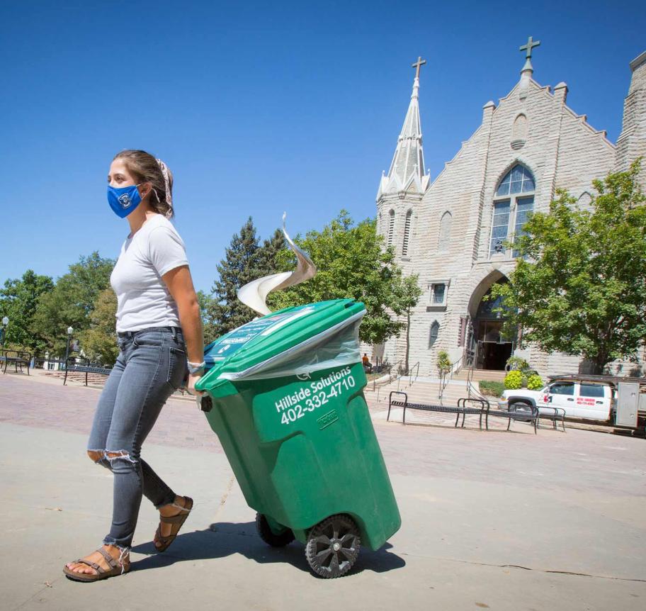 Sustainability student helping with recycling program