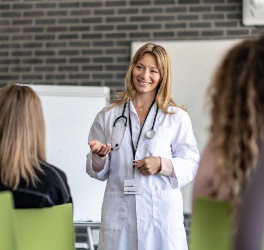 A healthcare professional teaching a group of people