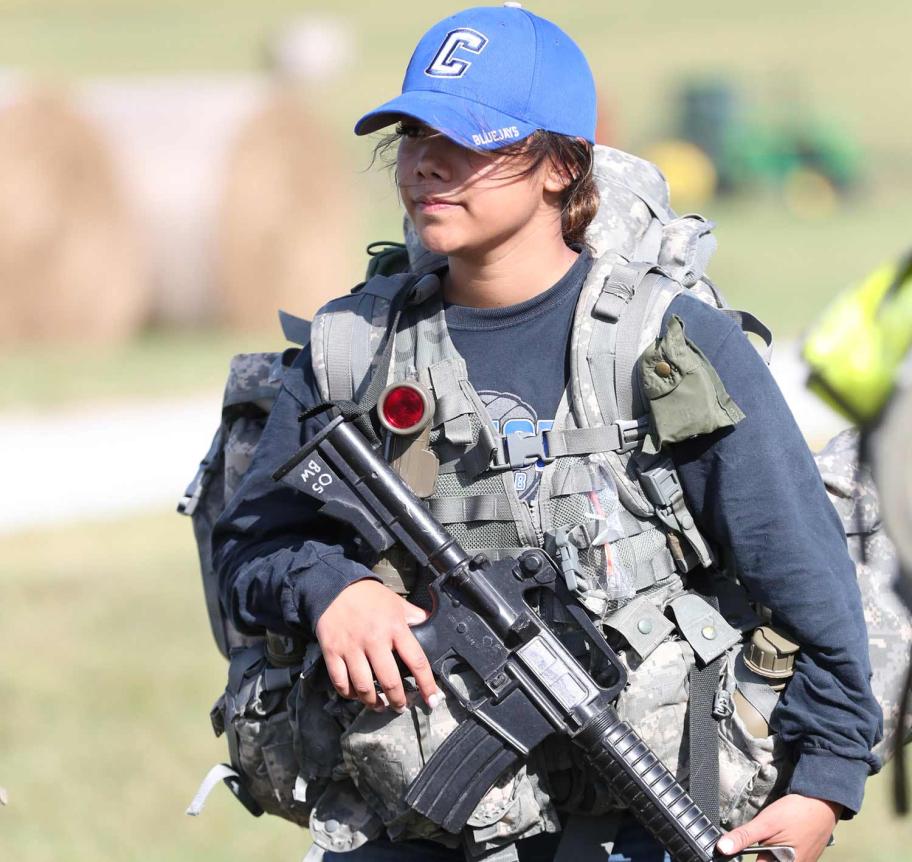 Military science student in the field wearing Creighton cap