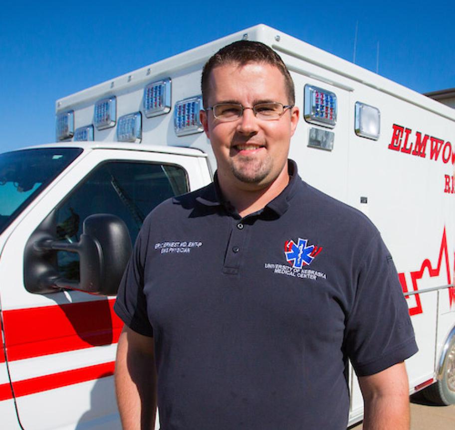 A man standing in front of an ambulance