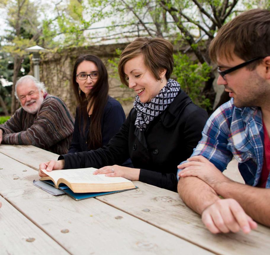 Students learning from faculty in an outdoor setting