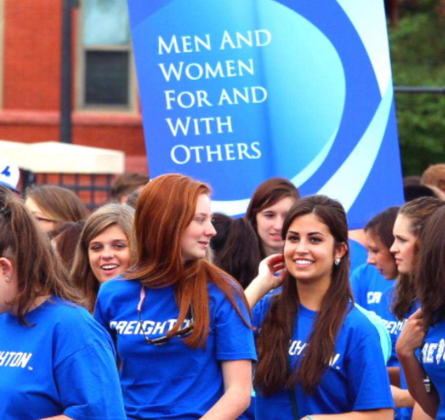 Female students gathered for campus activity all wearing Creighton shirts.