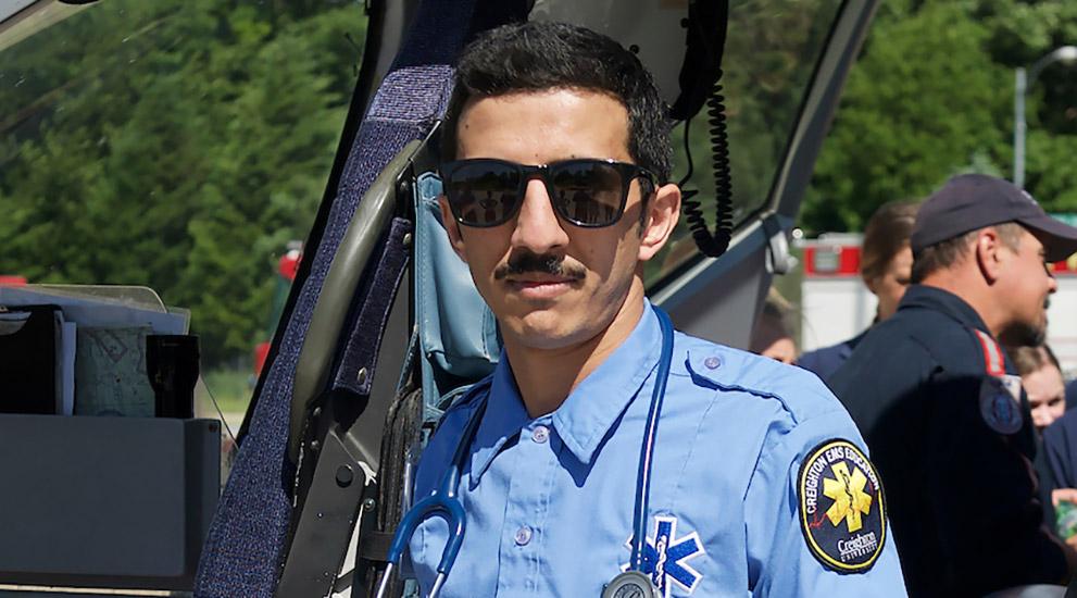 EMS student standing in front of a medical transport helicopter