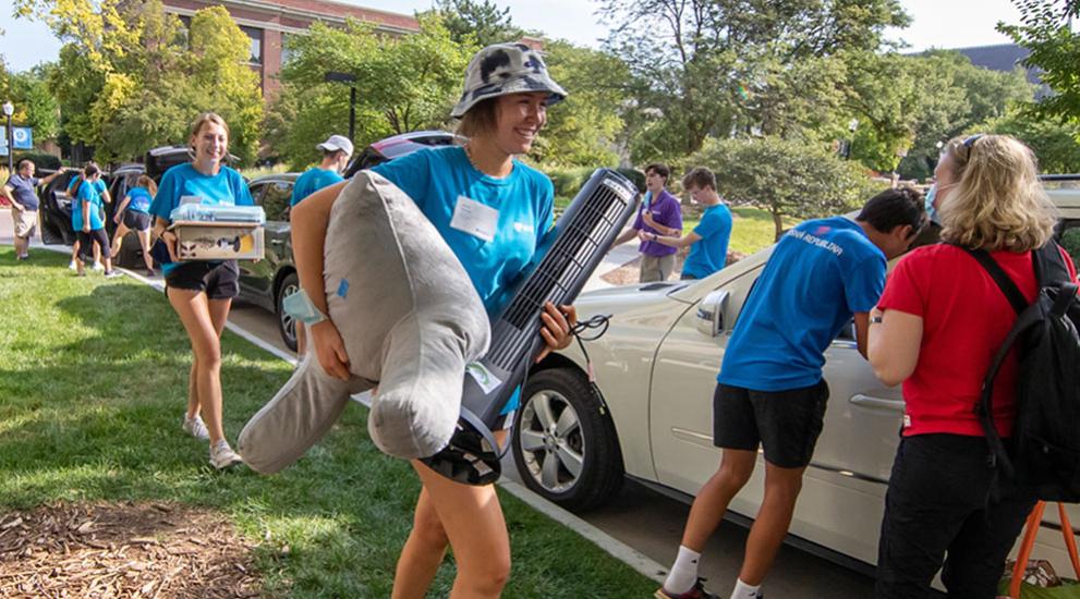 Students carrying items as they move into residence halls