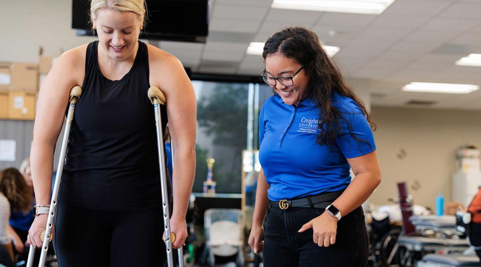 OT student helping pt with crutches