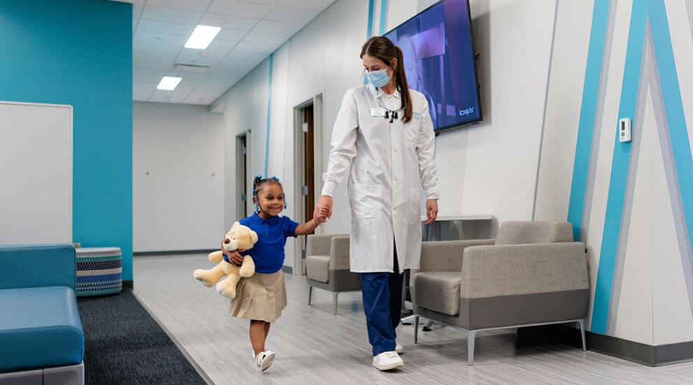 Dentist holding hands with child