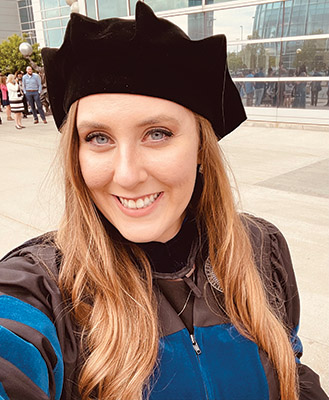 Sierra LaMotte selfie wearing graduation robe and cap.