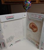 Krispy Kreme donut box used as going away card by fellow employees along with farewell balloon