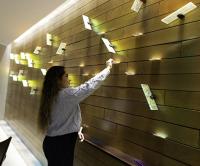 A student places a prayer request on the prayer petition wall of the Peter Faber, SJ, Chapel