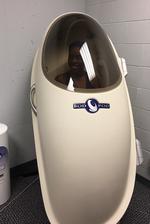 A person demonstrating Air Displacement Plethysmography (BodPod) Testing