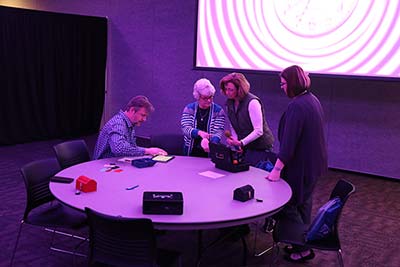 Participants working through the challenges in the Phishing Escape Room