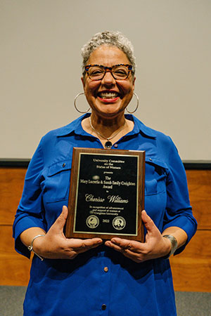 Charisse Williams holding her award plaque
