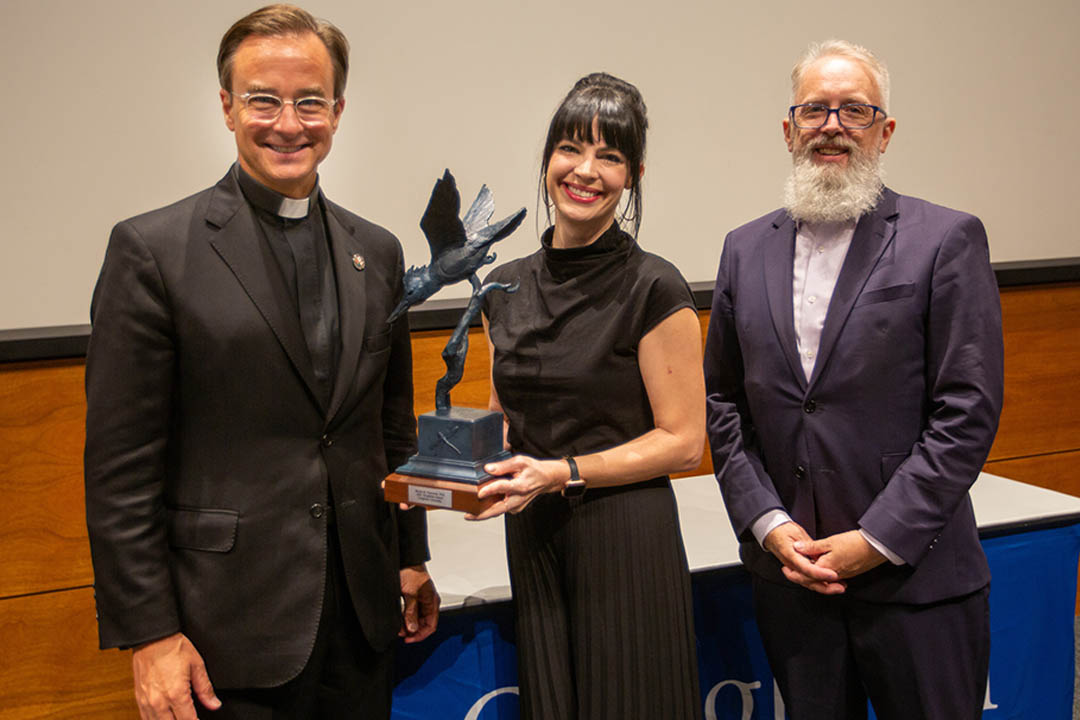Piemonte holding statuette by Dan Ostermiller, with Rev. Daniel S. Hendrickson, SJ, PhD and Leavelle.
