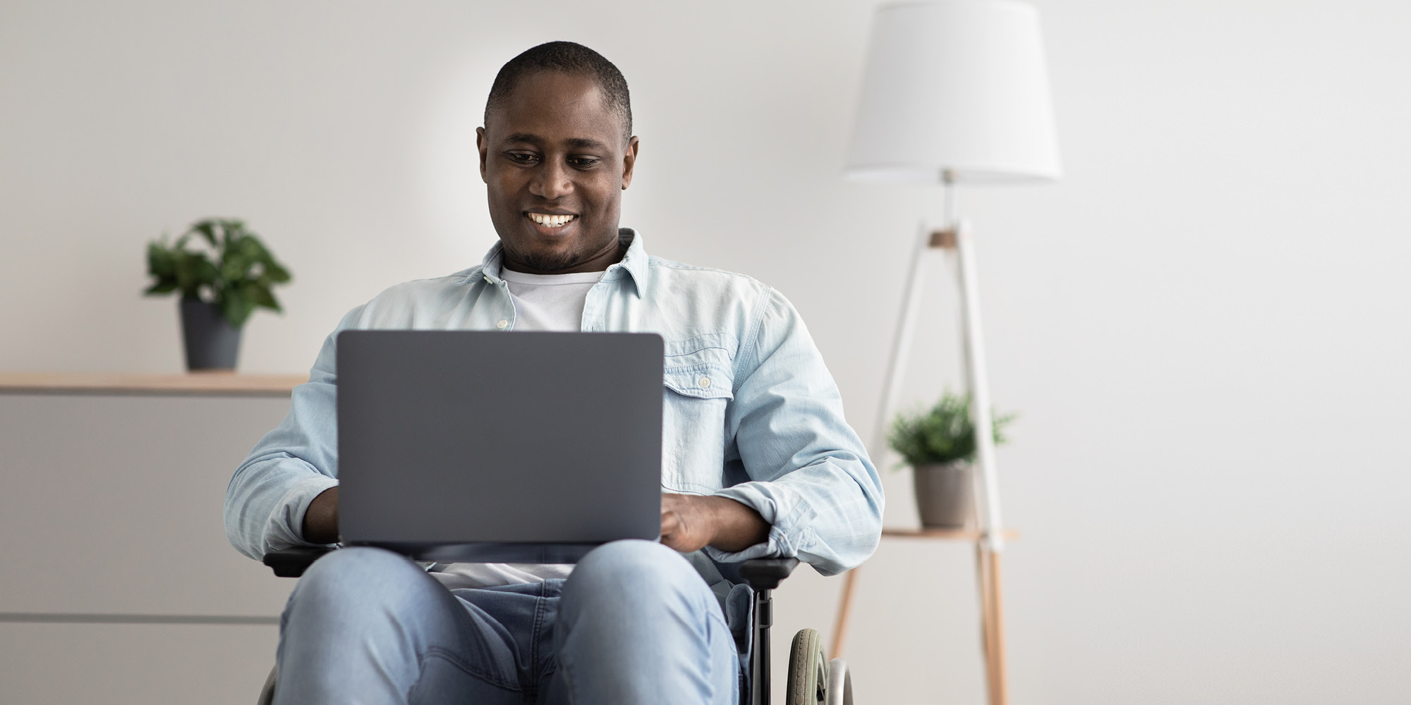 Student smiling on laptop