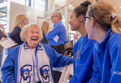 Ruth Scott greeting student athletes.