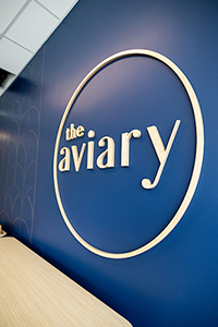 The Aviary wall logo