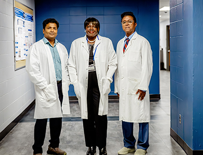 Creighton colleagues pose for photo on campus.