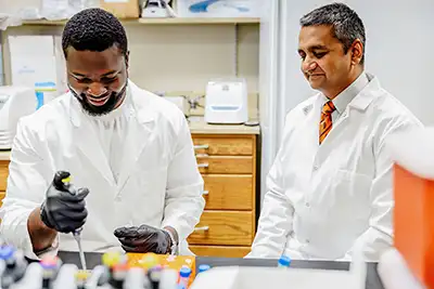 Sarkar in lab with colleague.