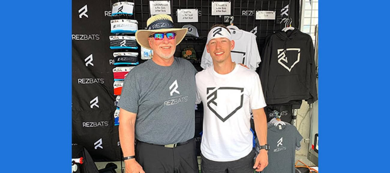 Ben Reznicek with father promoting his bats at the 2021 College World Series.