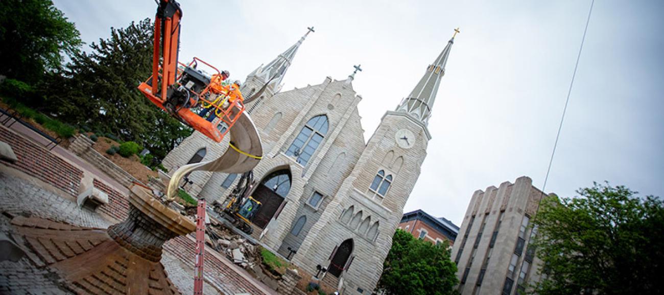 Workers ready the flame to be removed with a harness outside St. John's church.